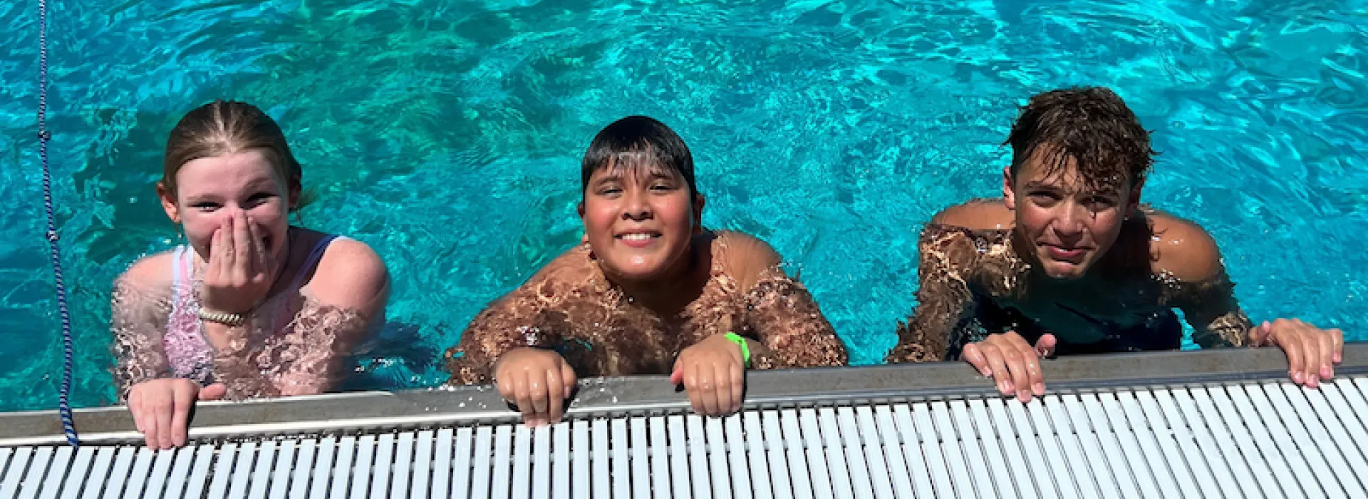 three swimmers in a pool